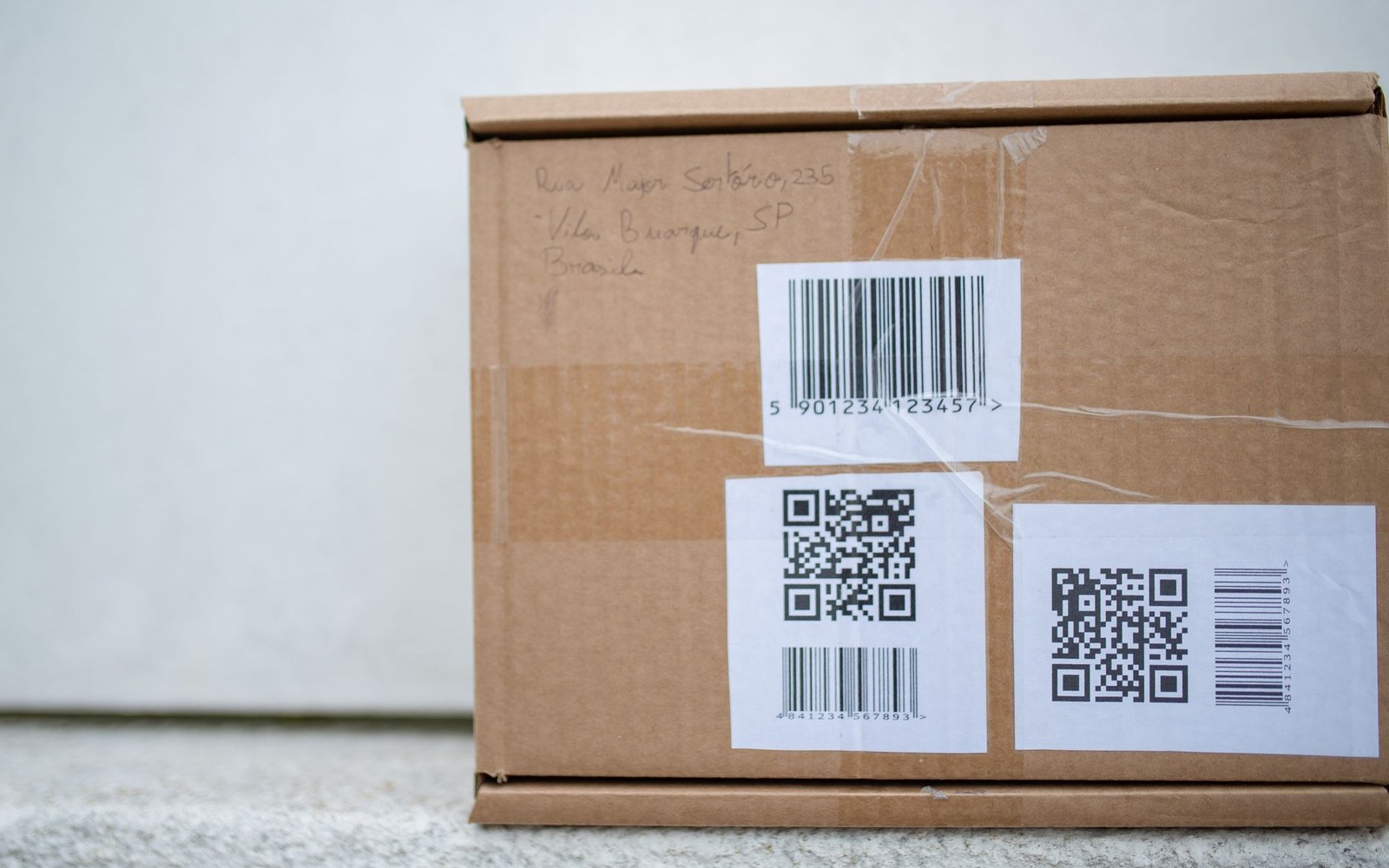 Close-up of a jacket's care label showing a QR code beside care symbols