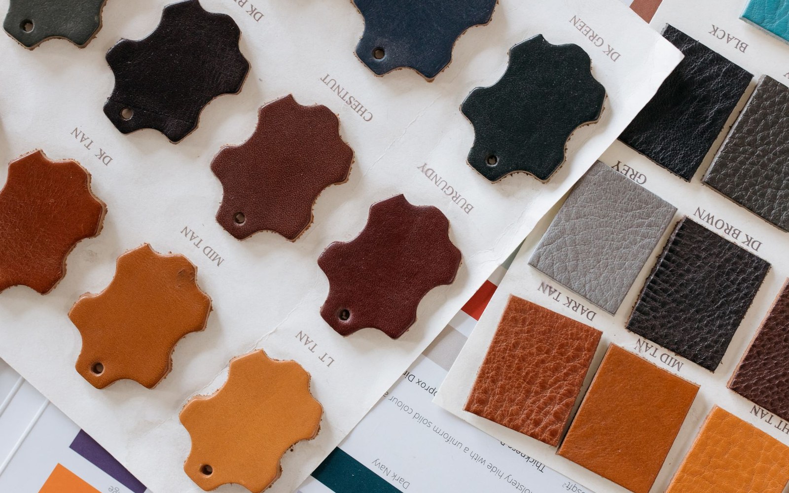 Leather swatch cards showing labeled color samples like chestnut, burgundy, tan and black